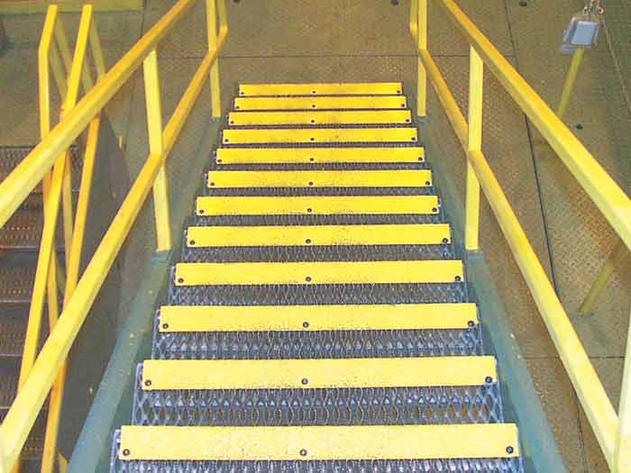 Yellow step covers installed on serrated grating